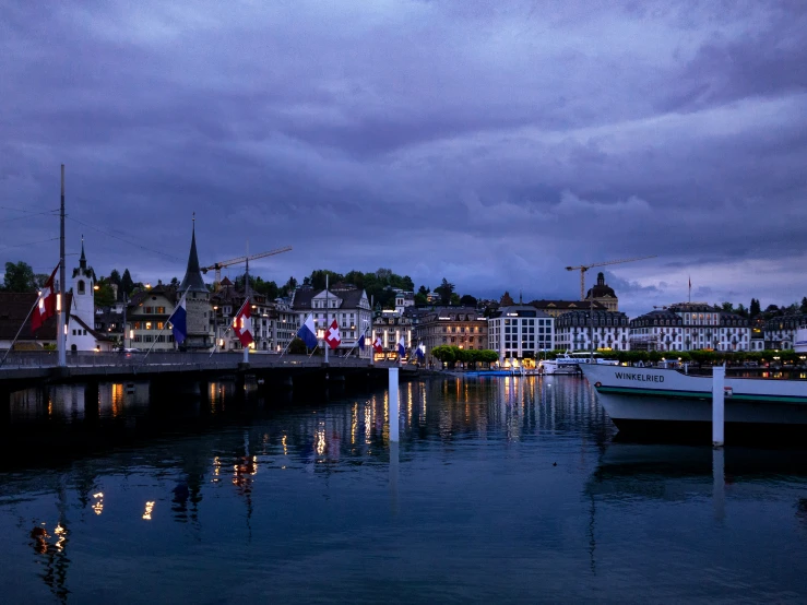 boats on the river at dusk in a city