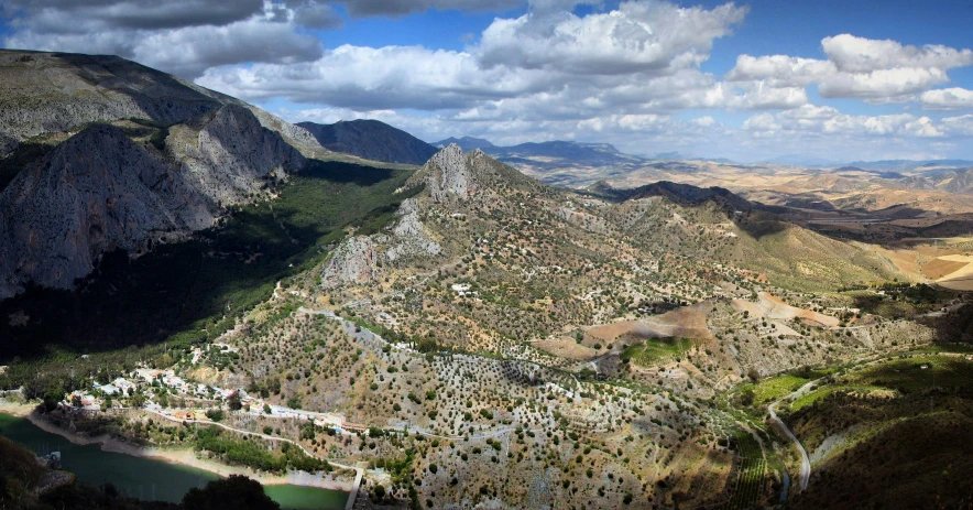 there are mountains around a city in the wilderness