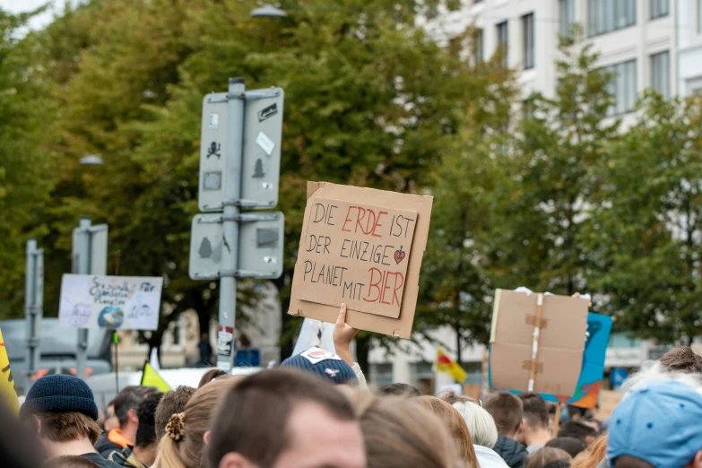 a group of people standing in the street holding signs