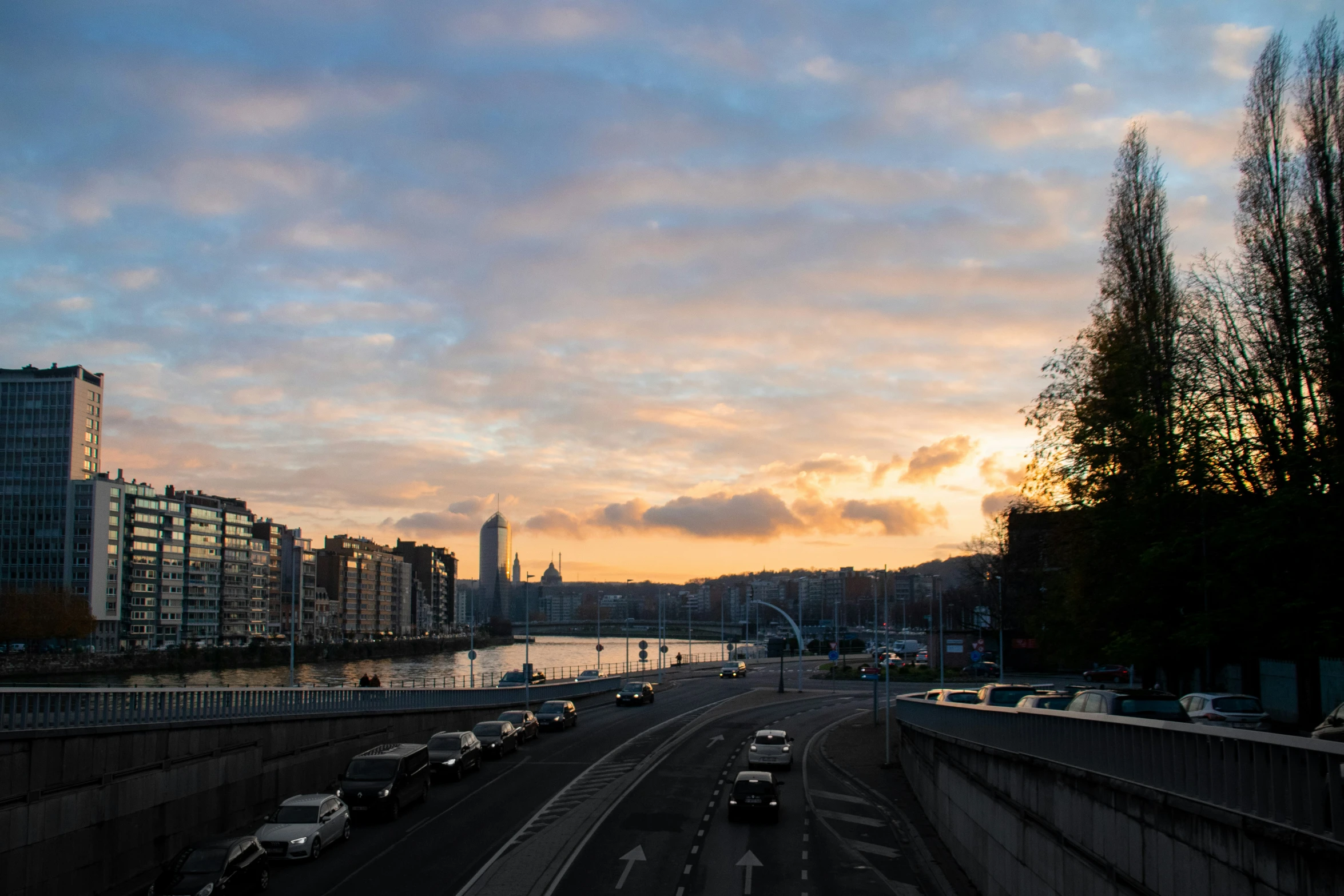 the traffic is moving down the road at dusk