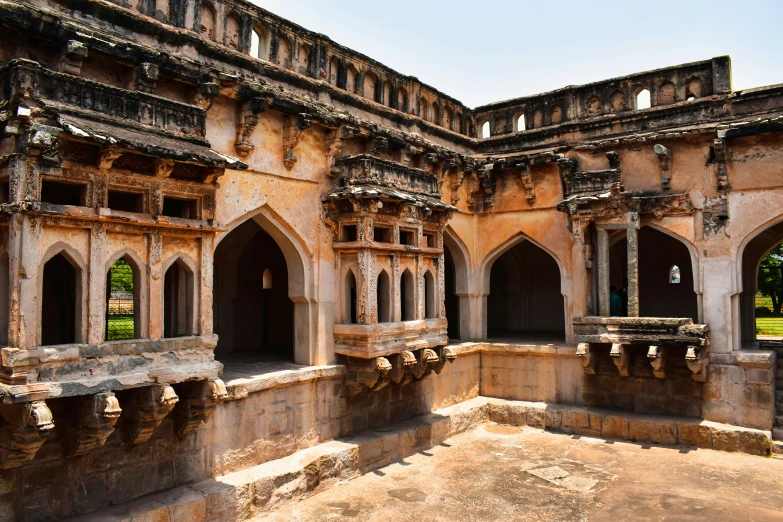 an intricate stone building with a circular doorway and windows