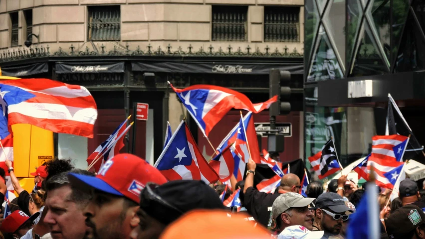 a group of people carrying puertonian flags