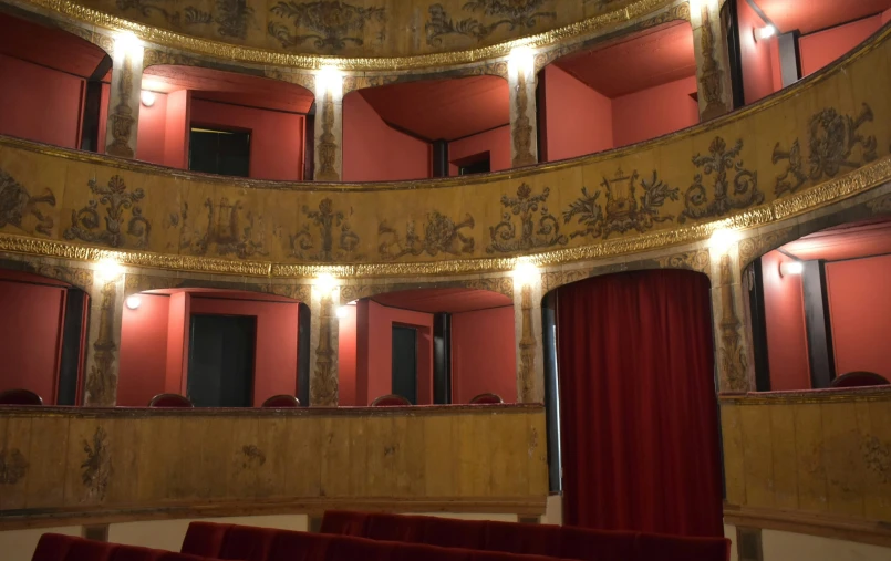 a large theatre is decorated in red velvets