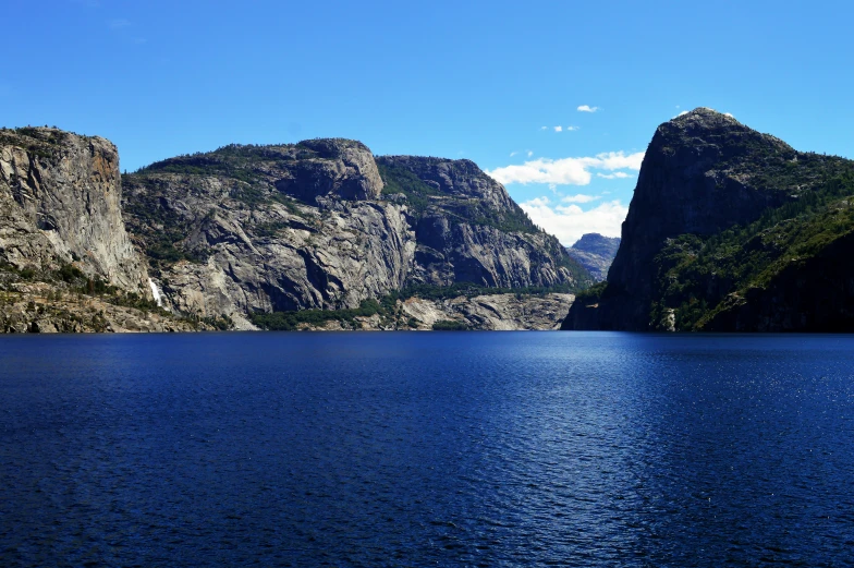 the view from the side of a mountain across a lake