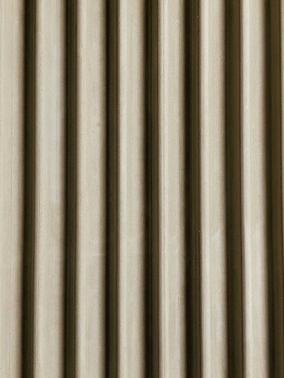 a tan curtain with brown horizontals that are ded