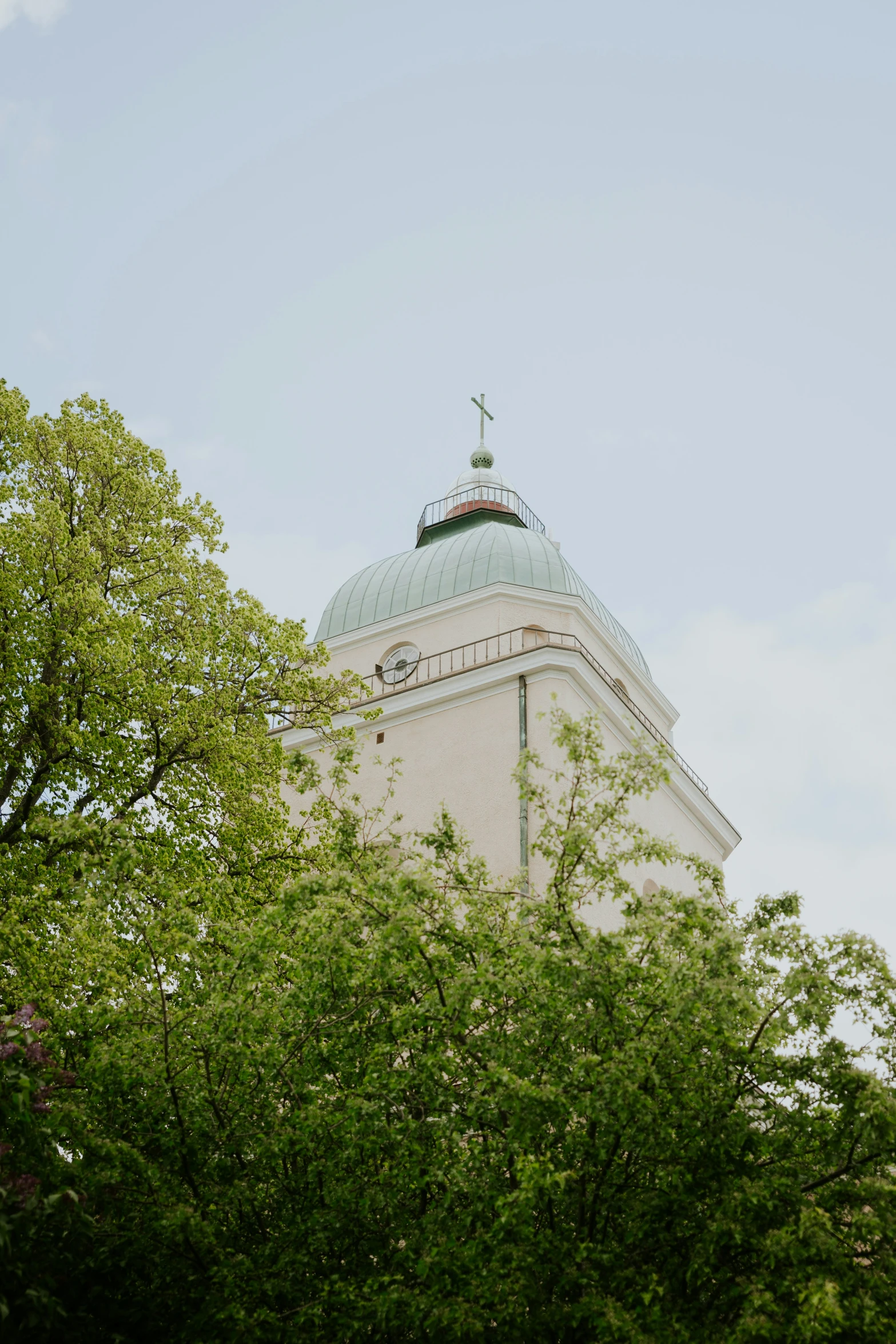 a tower with some lights on top and trees