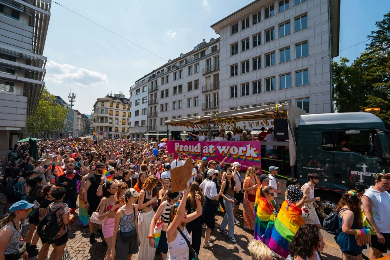 large crowd of people gather together in a city