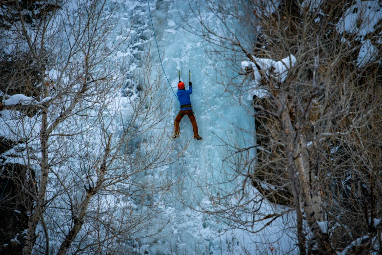 a man on skies is standing in the middle of an icy river