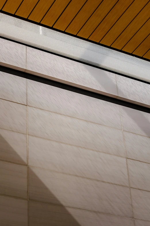 a bench in front of a wood wall and ceiling