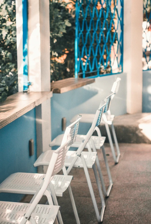 a row of benches on the street in front of an entrance