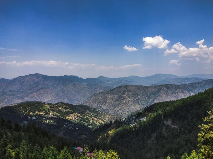 a view of mountains with valleys in the distance