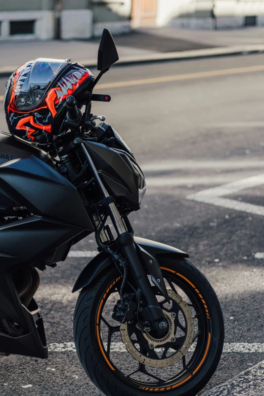 a motorcycle parked on the road by some buildings