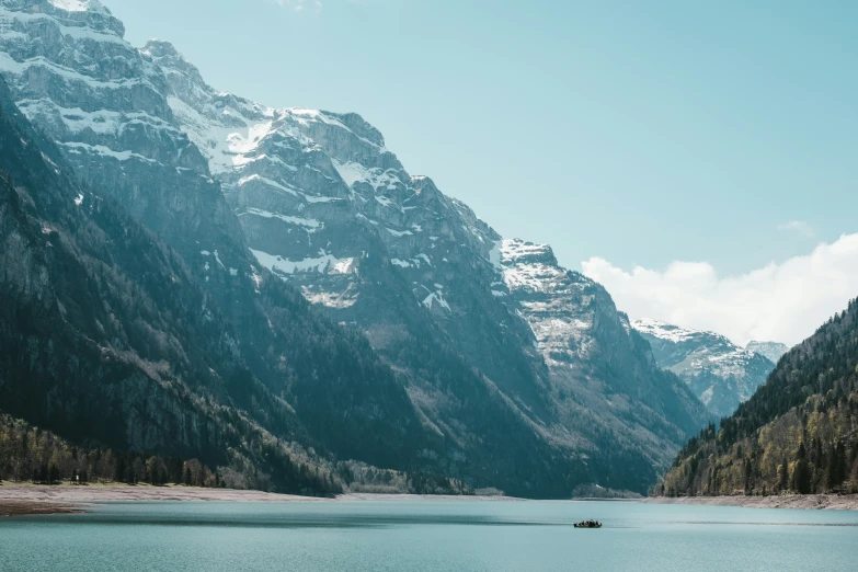 mountains are in the distance behind a lake