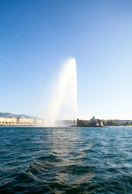 the fire hydrant is spraying water on a lake