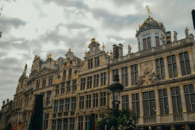 a building with ornate architecture and two street lamps in front of it