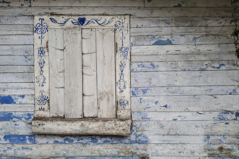 an old white window with a blue design on it