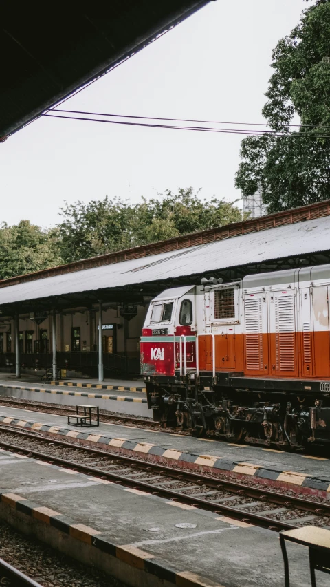 a train sitting on a track next to a train station