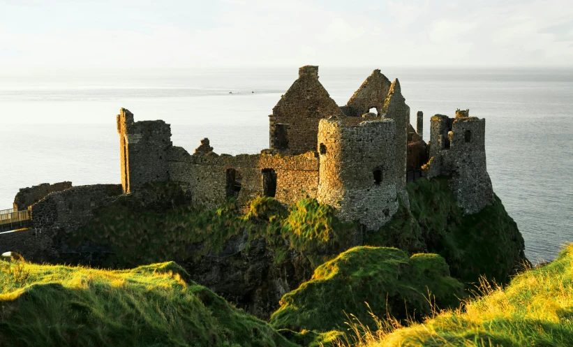 an old castle perched on a hill overlooking the water