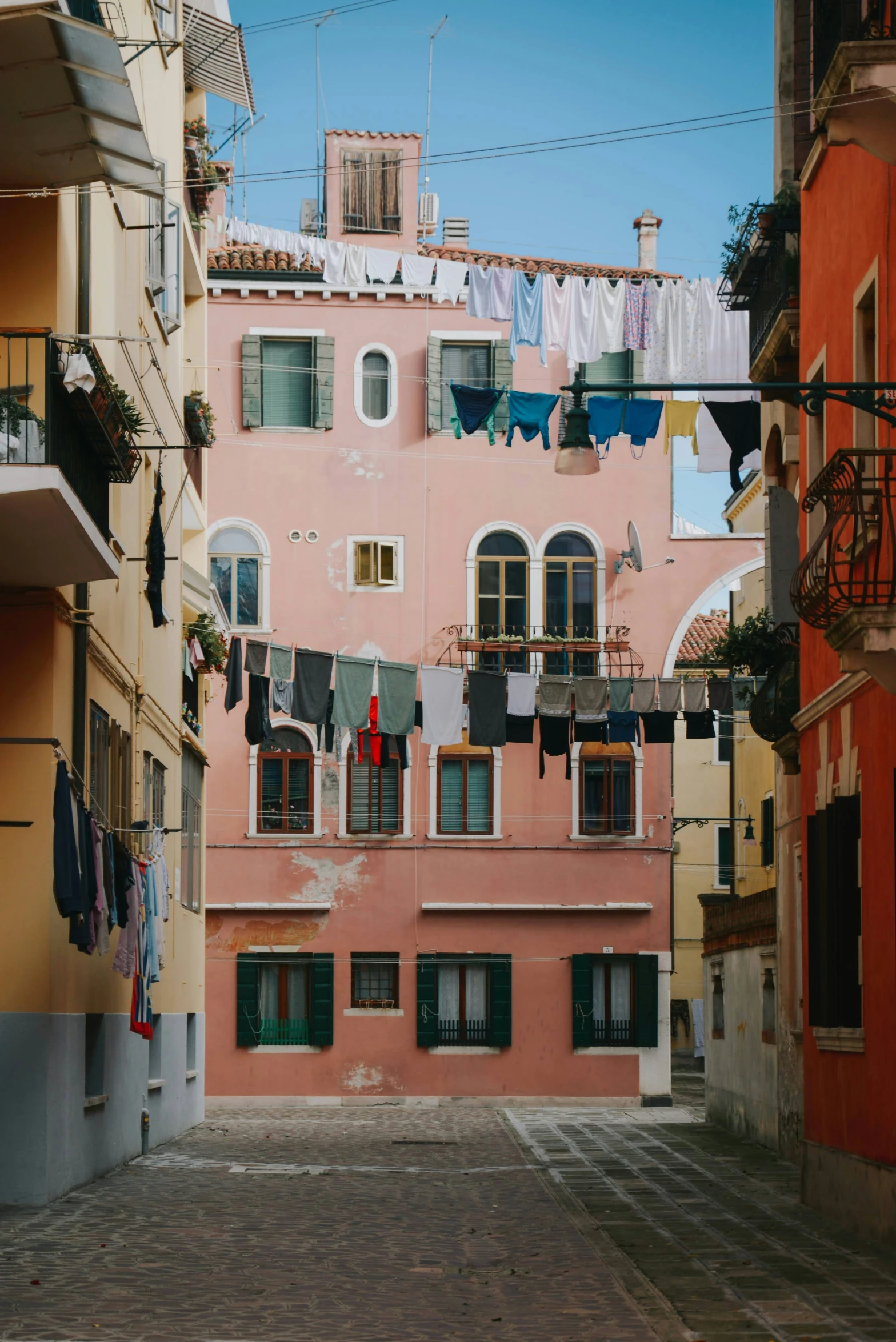 a building with laundry hanging outside on a street