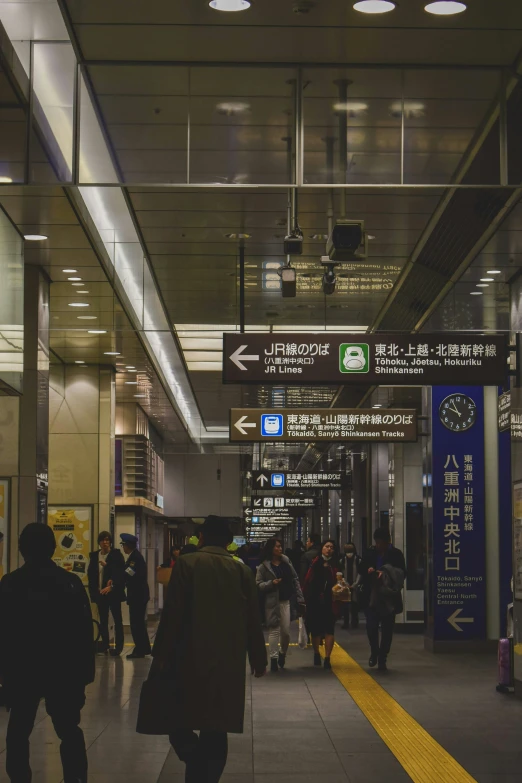 several people are walking down a narrow hallway