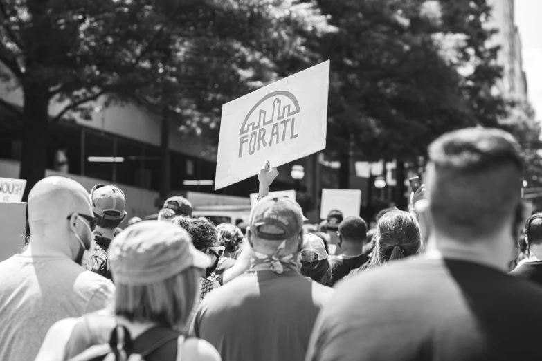 people are holding up signs in the middle of a street