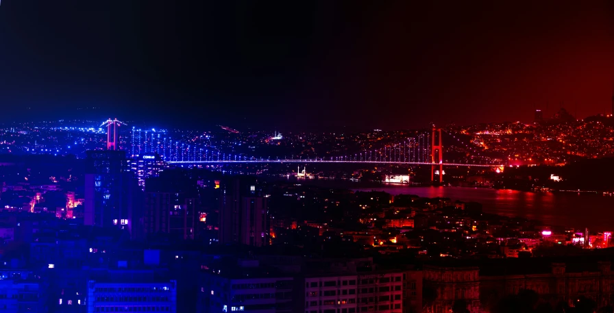 this is a picture taken from a high rise looking down at the city lit up with colorful lights