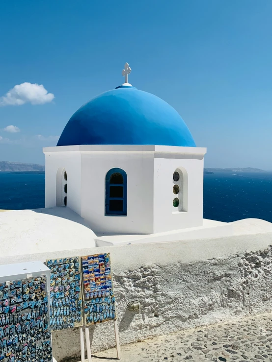 a blue and white building overlooks a vast ocean