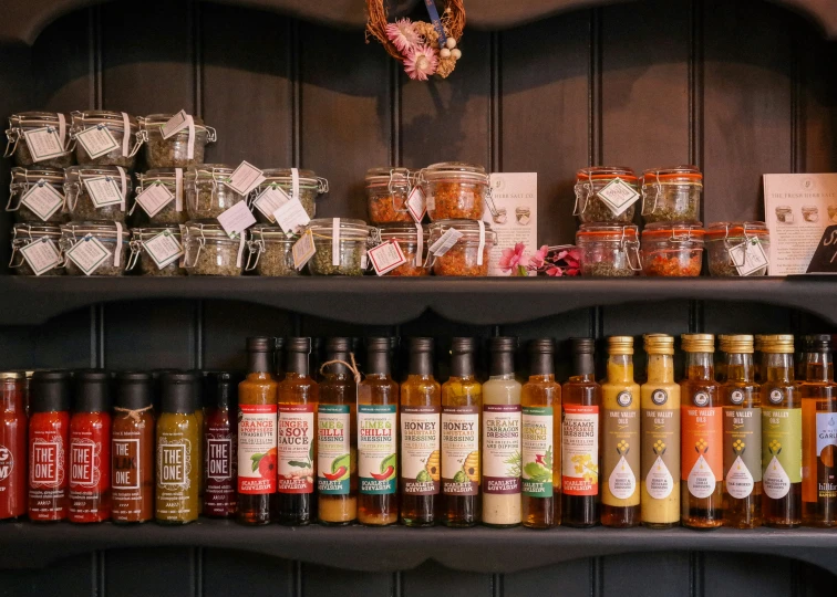 a couple of shelves filled with different kinds of sauces