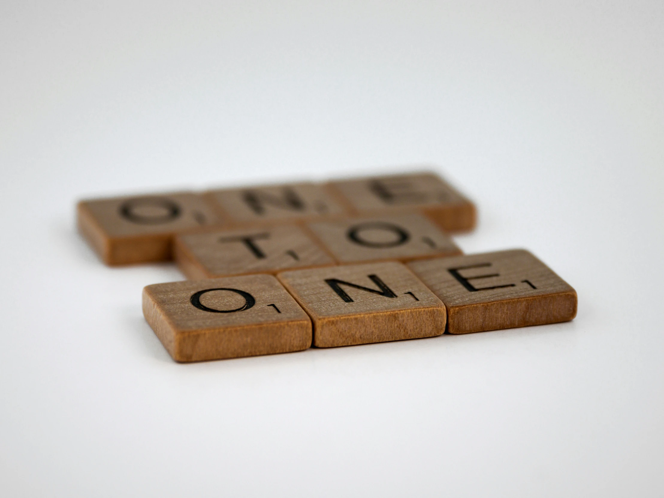 two words made out of tiles are shown with one letter spelling out the word'online to see '