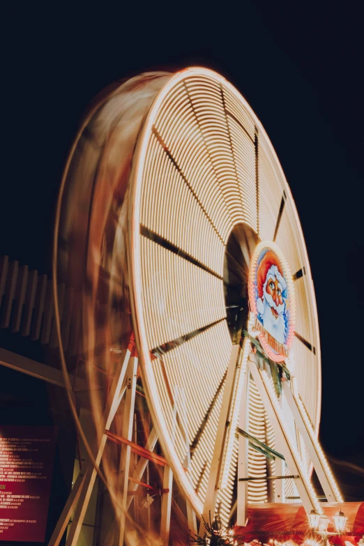 the ferris wheel spinning in the evening at a carnival