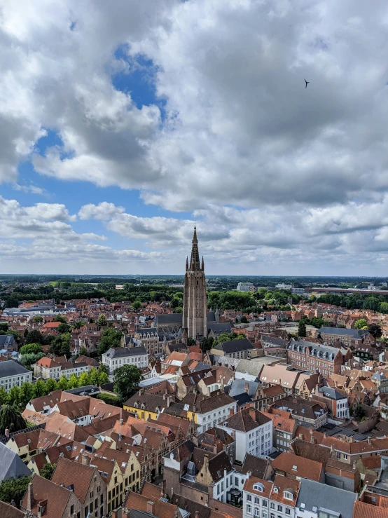 the view from above of a city looking at a tower