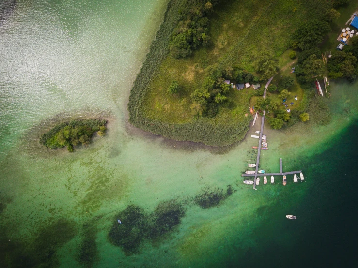 an aerial s of a beach with boats in the water