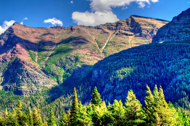 some tall mountains that are covered with grass