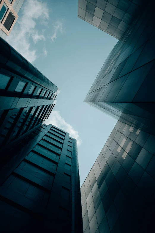 the bottom view of tall buildings from under