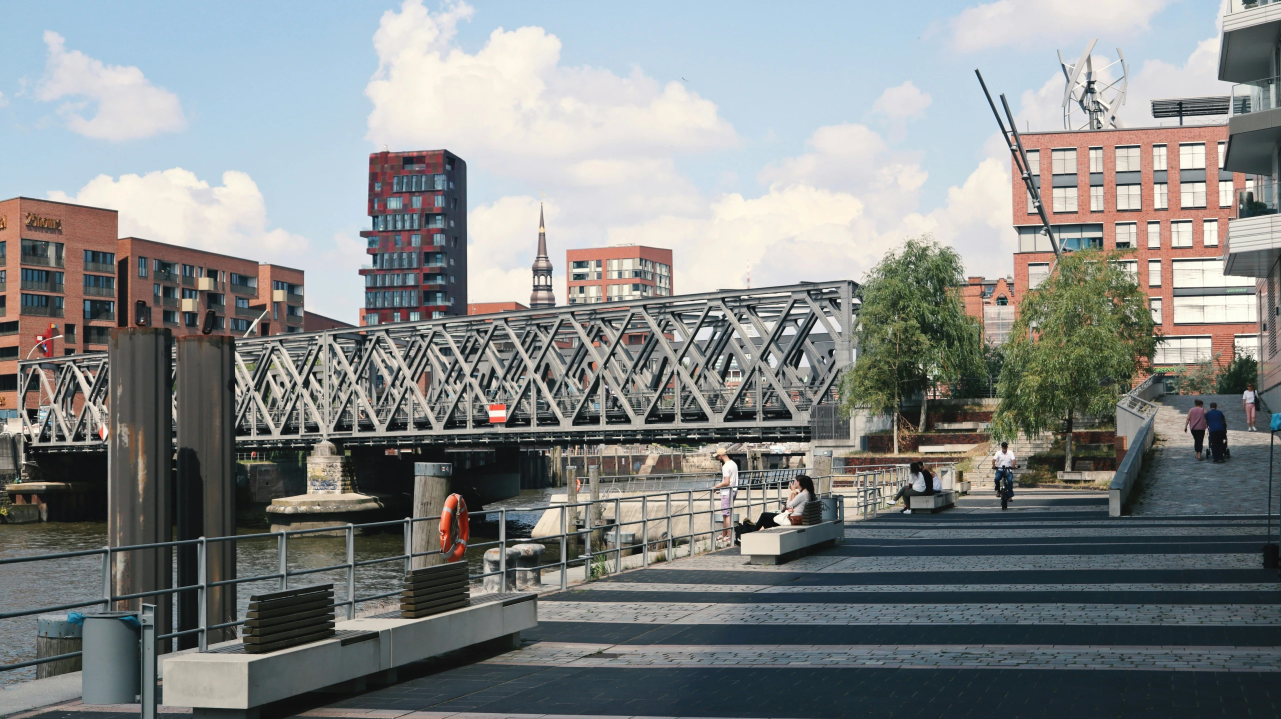 bridge in the city with a few people walking on the pathway