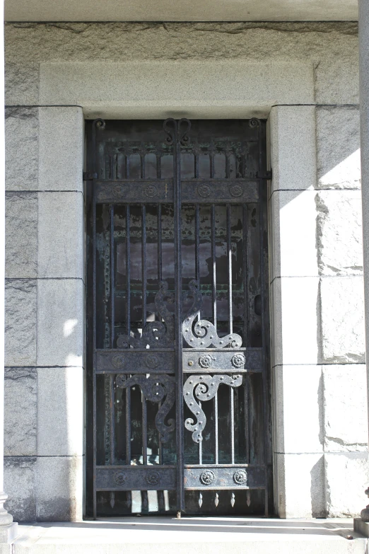 a large iron gate in a building next to a window