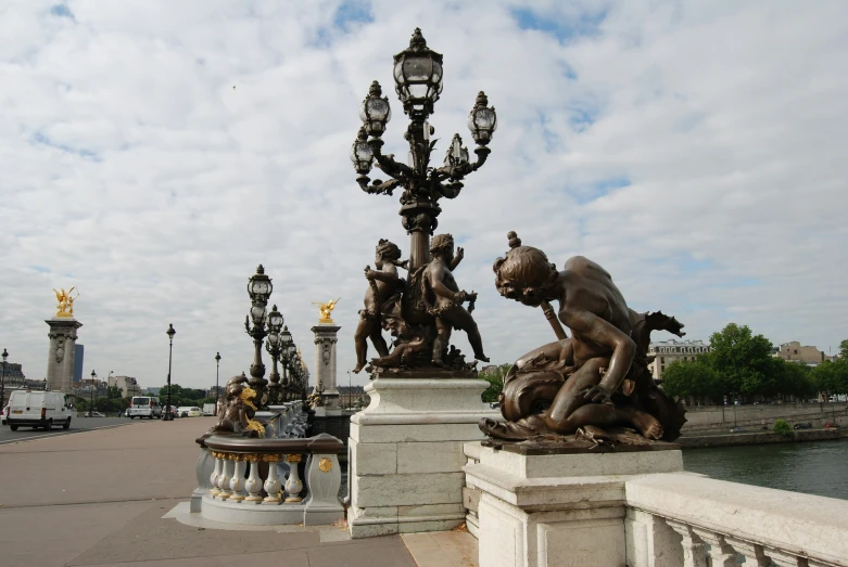 a lamppost with three sculptures on top