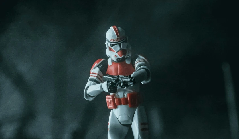 a star wars figurine is posed with a gun