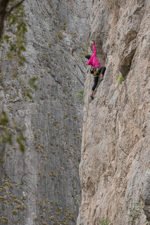 someone is rapping along side of a steep rock face