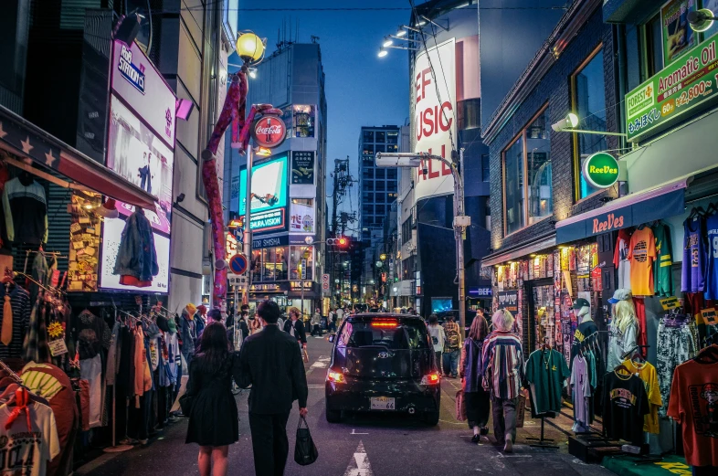 people walking along the side walk in an urban area