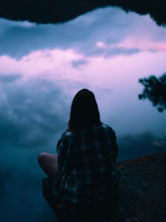 a person sitting in the foggy mountains