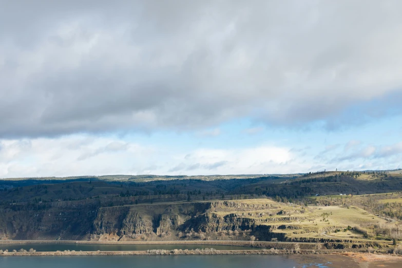 a scenic lake and mountains are seen from afar