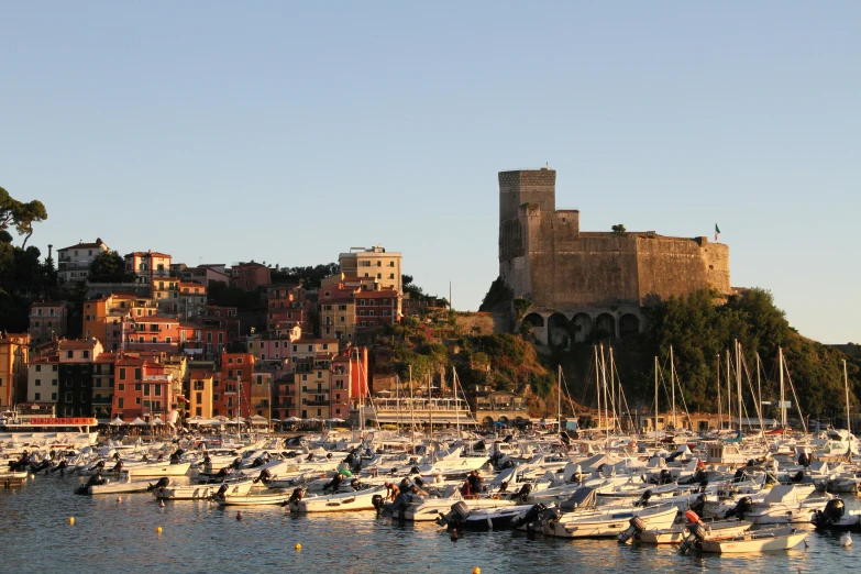 boats and ships in the water near a building