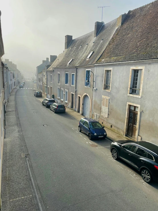 an old european street lined with parked cars