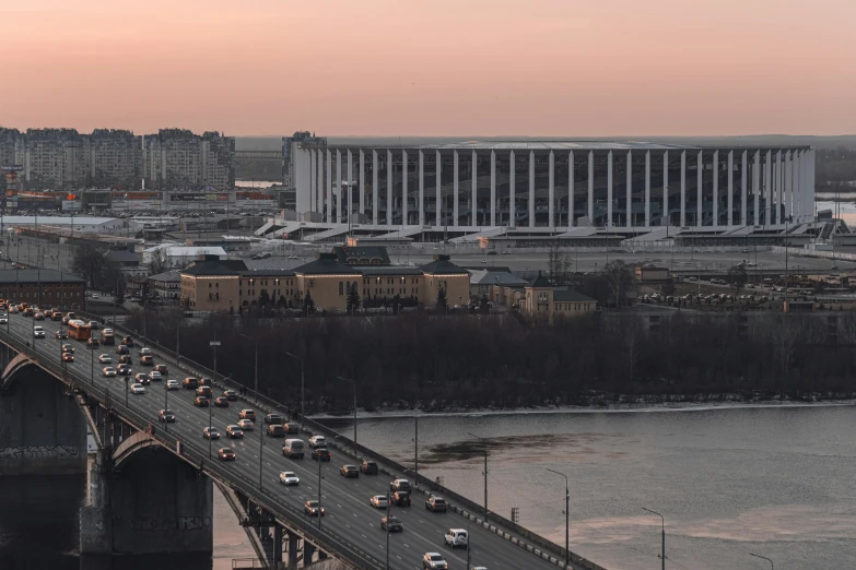 traffic on an elevated road and a city with a bridge over water