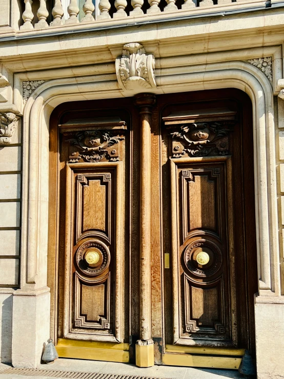 two golden double doors sit in front of an old building