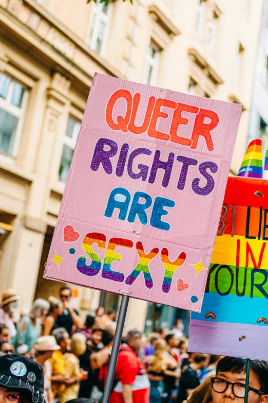 a group of people standing next to each other holding up signs