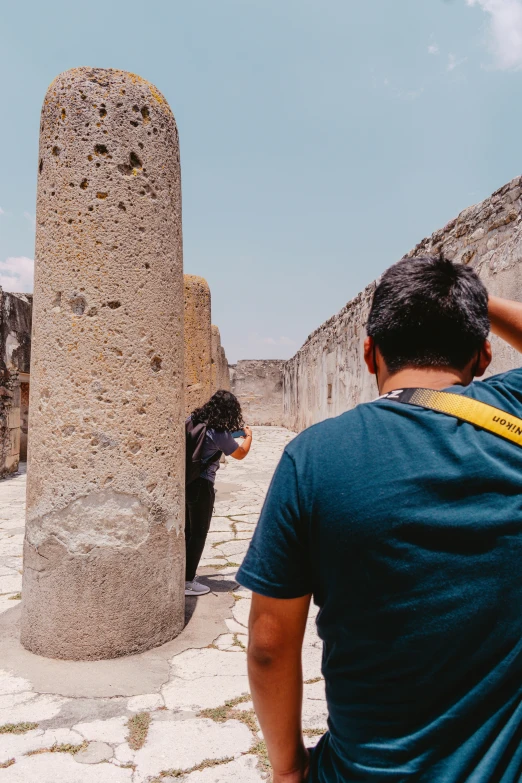 people standing around an ancient brick structure