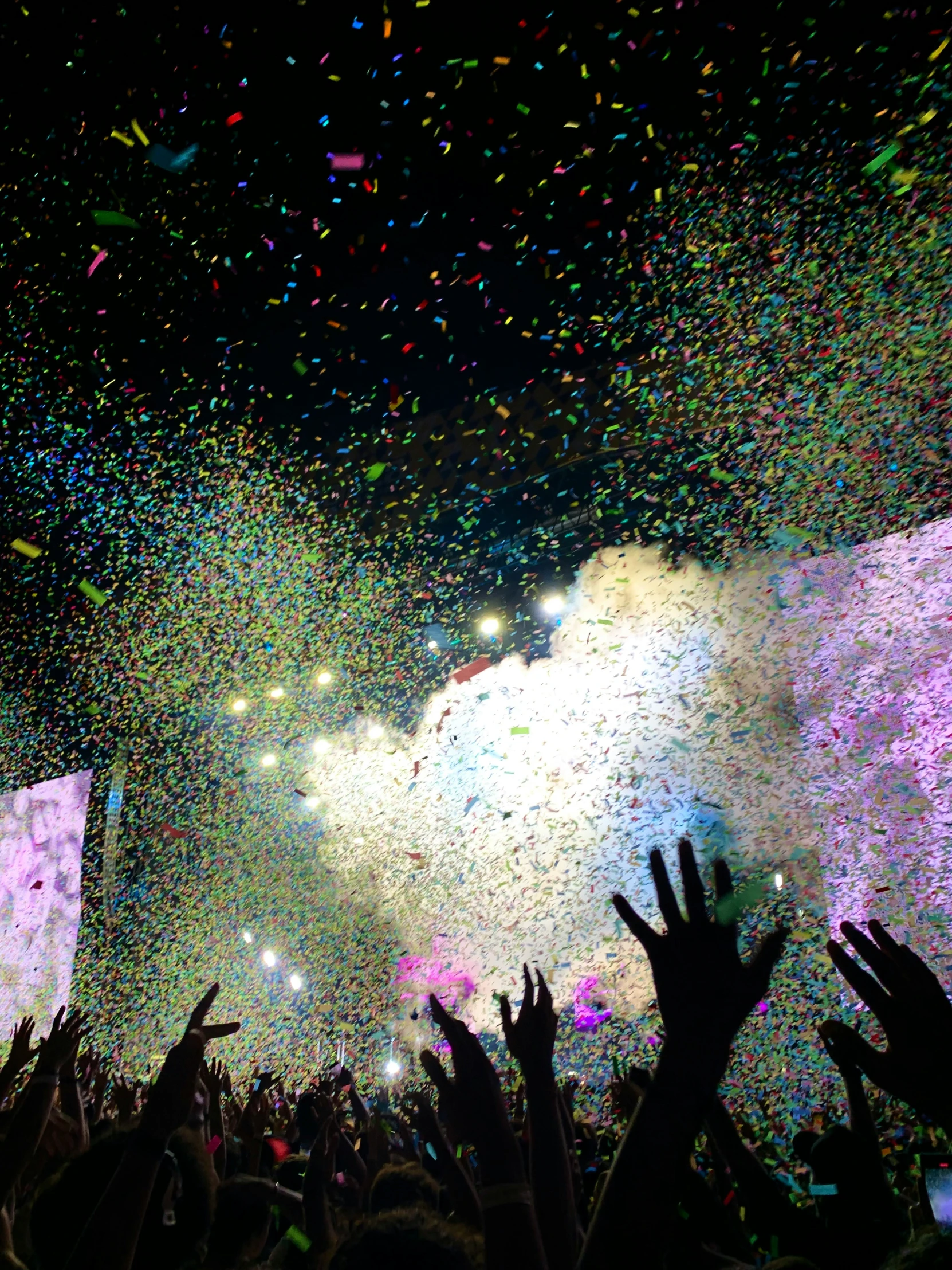 confetti and streamers are thrown from the crowd at a concert