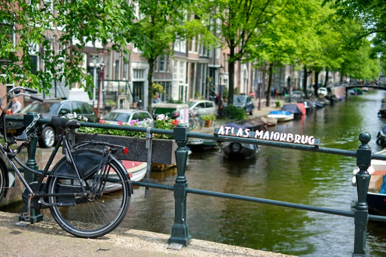 a bicycle is sitting in front of a railing